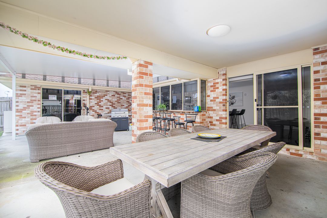 Outdoor entertainment area with wooden table and seating.